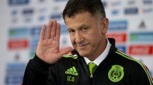 Juan Carlos Osorio, newly-appointed head coach of Mexico's national soccer team, waves after donning his team jacket during a press conference in Mexico City, Wednesday, Oct. 14, 2015. (AP Photo/Rebecca Blackwell)